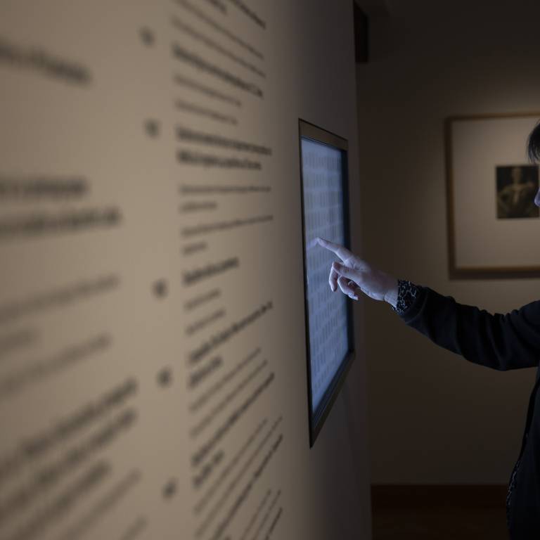 Visitor consulting the digital panel in the Steichen cabinet